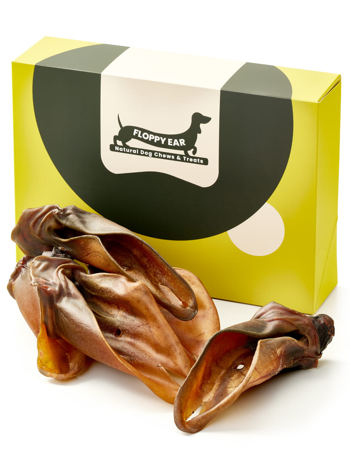 Floppy Ear Beef Ears Chew Box closed with several natural dried beef ears arranged in the foreground