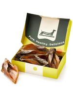 Floppy Ear Beef Ears Chew Box open at an angle showing natural dried beef ears inside with "Pure. Healthy. Delicious." on the lid