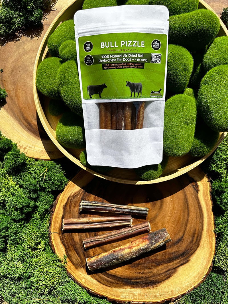 Floppy Ear 100% Natural Air Dried Bull Pizzle Chew 4-pack pouch in bamboo bowl with moss