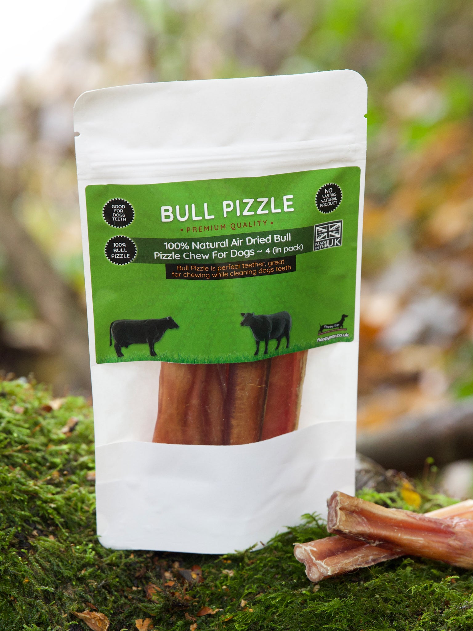 Floppy Ear Bull Pizzle Premium Quality Air Dried Dog Chew pouch with loose pieces on moss