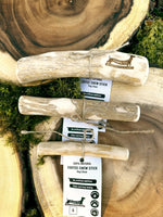 Floppy Ear Coffee Chew Stick Small Medium and Large sizes on wooden slice with moss