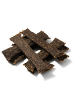 Floppy Ear 100% Natural Air Dried Deer Meat Strips close up on moss