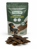 Packaging of Floppy Ear deer meat strips for dogs with a pile of strips in front.