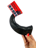 Hand holding a medium natural buffalo horn dog chew from Floppy Ear – long-lasting, low fat, supports dental hygiene