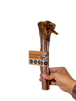 Hand holding a large natural ostrich bone dog chew from Floppy Ear – air-dried, long-lasting, low fat dental chew for dogs