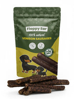Floppy Ear 100% natural Venison Sausages dog treats pouch with loose sausages in foreground and dachshund illustrations