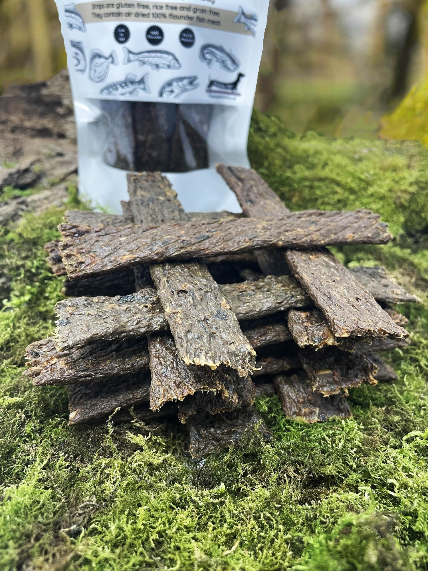 Floppy Ear 100% Natural Air Dried Flounder Fish Meat Strips close up on moss