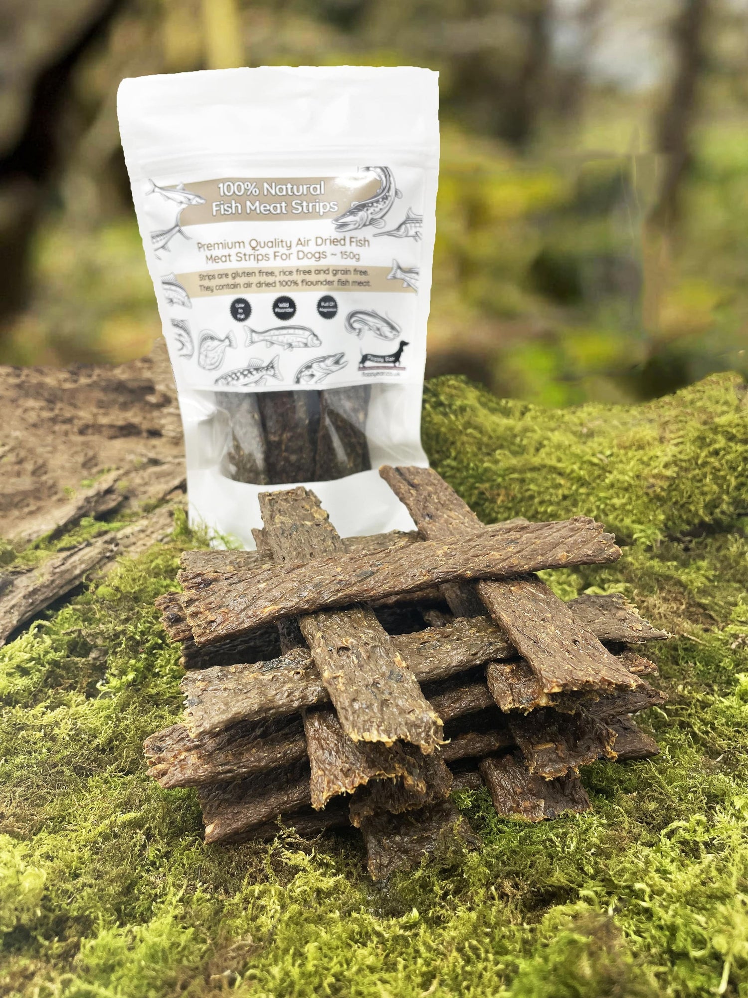 Floppy Ear 100% Natural Fish Meat Strips 150g pouch on moss with loose strips