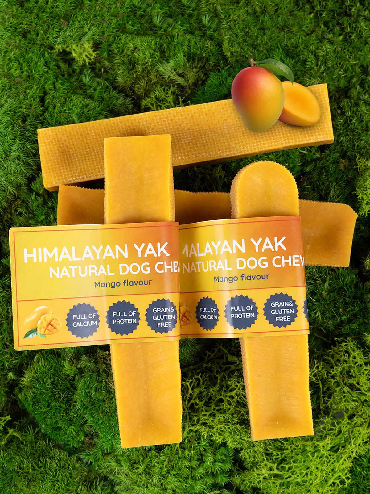 Floppy Ear Himalayan Yak Chews Mango Flavour Medium and Large sizes on moss background with mango