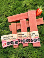 Floppy Ear Himalayan Yak Chews Strawberry Flavour Medium, Large and XL sizes on moss with fresh strawberries