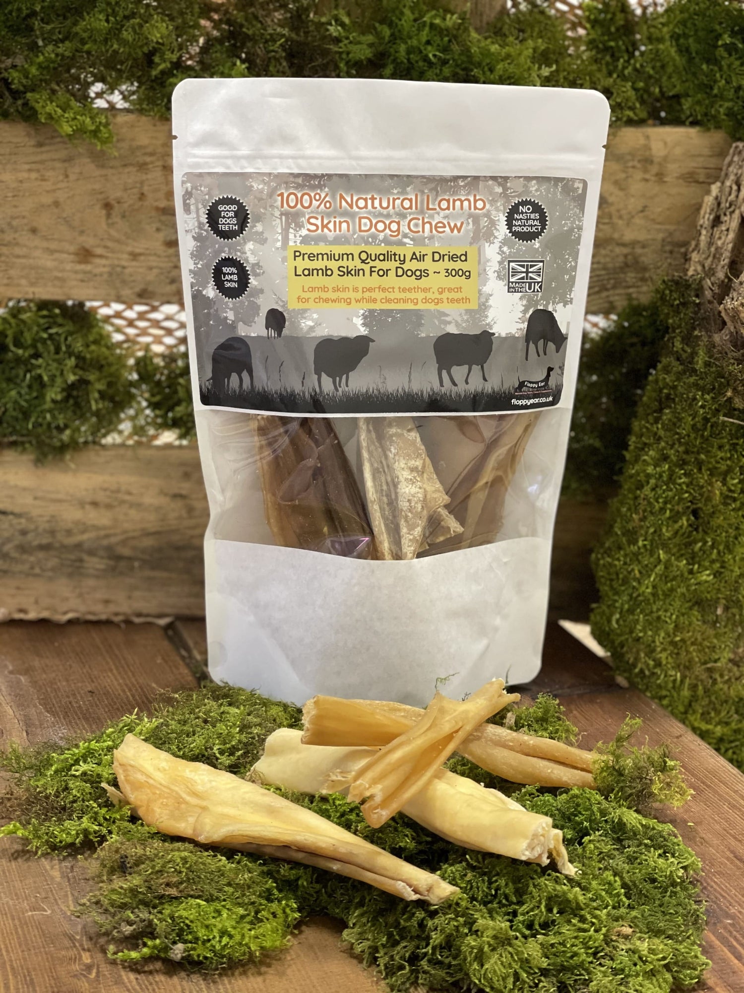 Floppy Ear 100% Natural Lamb Skin Dog Chew 300g pouch with loose strips on moss