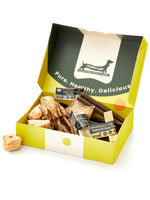 Floppy Ear Medium Puppy Box open at an angle showing variety of natural dog chews including Himalayan yak, red deer antler and beef strips with "Pure. Healthy. Delicious." slogan