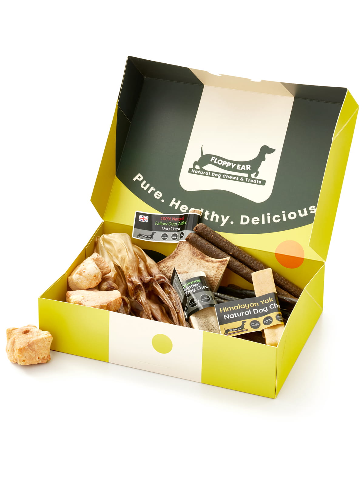 Floppy Ear Medium Puppy Box open at an angle showing variety of natural dog chews including Himalayan yak, red deer antler and beef strips with "Pure. Healthy. Delicious." slogan