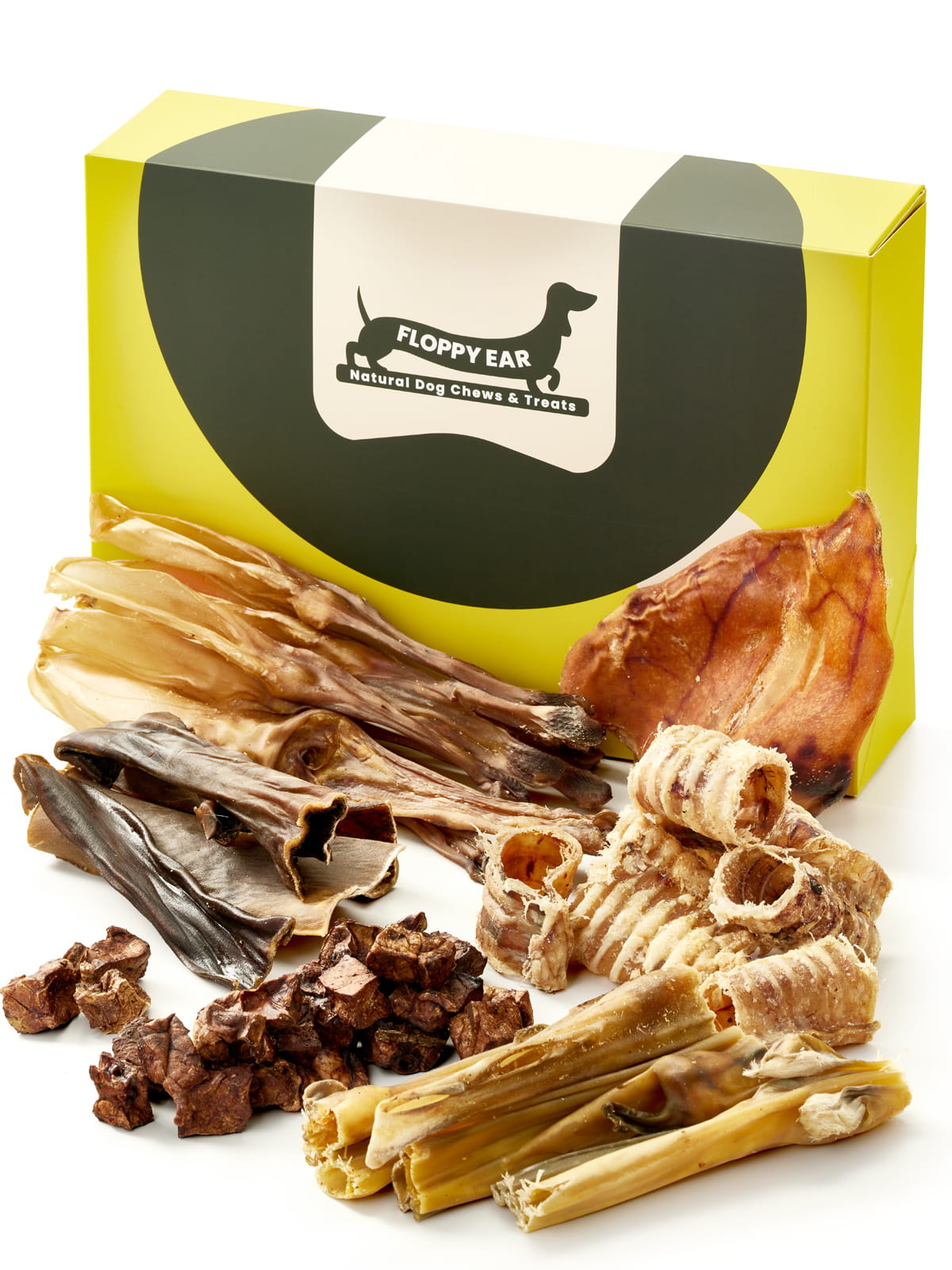 Floppy Ear Natural Chews & Treats Box closed with large selection of natural dog chews arranged in the foreground