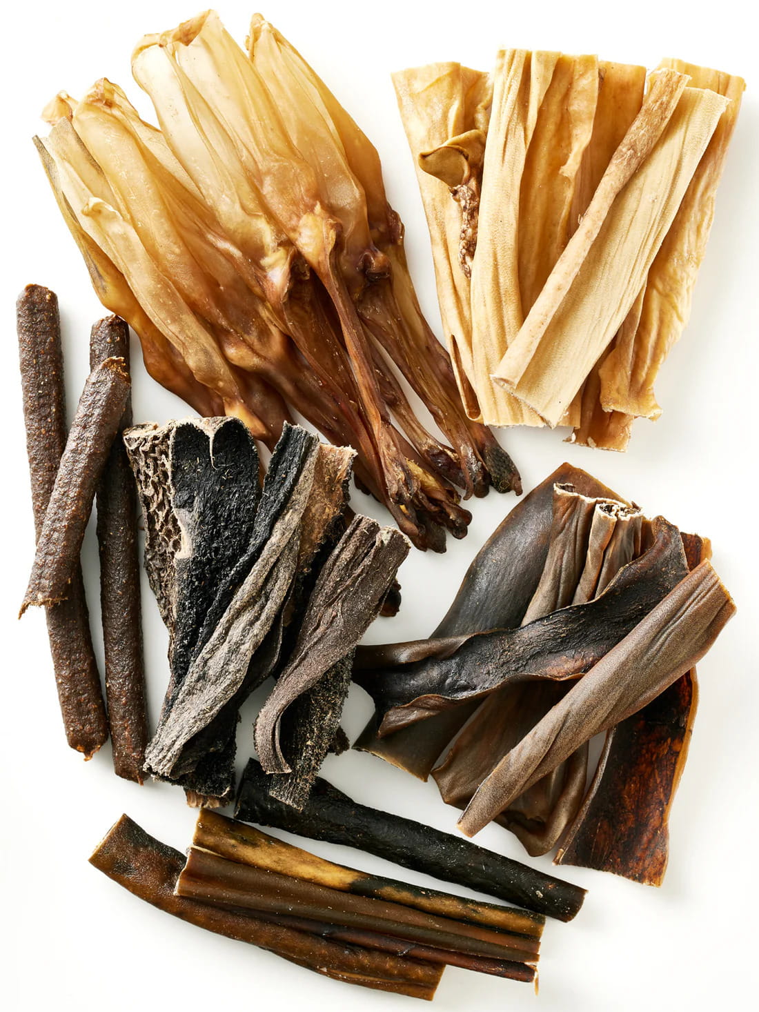 Assortment of natural dog chews and treats from Floppy Ear - variety of premium single-ingredient chews on white background