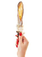 Hand with red nails holding single Floppy Ear natural rabbit ear with fur chew showing the fluffy fur side and texture