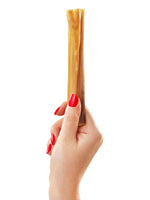 Hand with red nails holding single Floppy Ear natural dried rabbit skin chew showing texture and length