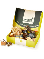 Floppy Ear Small Puppy Box open at an angle showing variety of natural dog chews including Himalayan yak, red deer antler and beef strips with "Pure. Healthy. Delicious." slogan