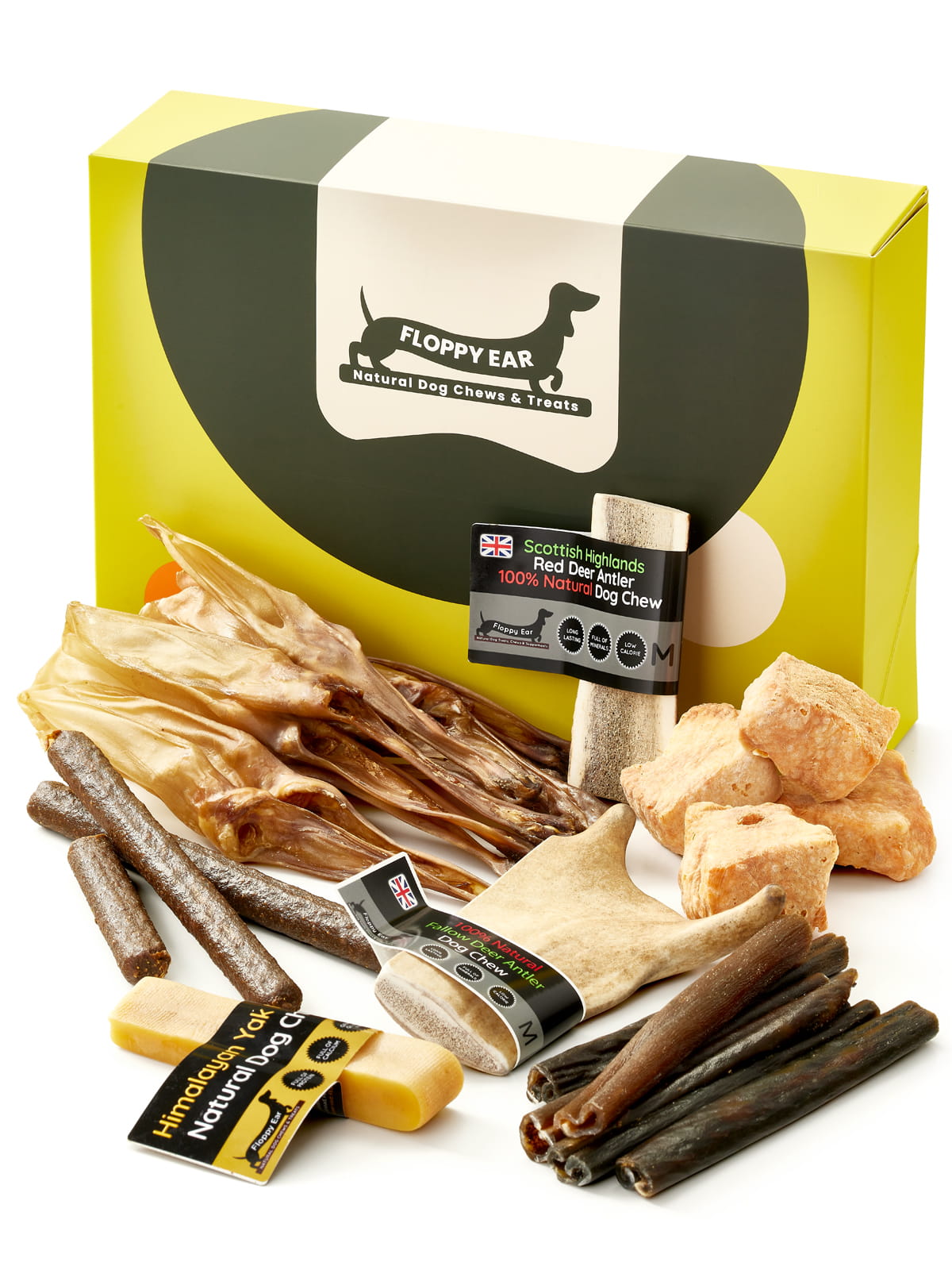 Floppy Ear Medium Puppy Box closed with selection of natural dog chews and treats arranged in the foreground